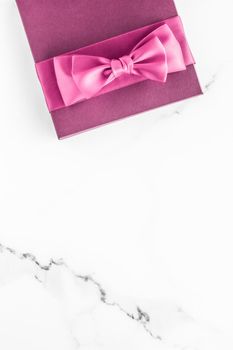 Birthday, wedding and girly branding concept - Pink gift box with silk bow on marble background, girl baby shower present and glamour fashion gift for luxury beauty brand, holiday flatlay art design