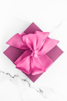 Birthday, wedding and girly branding concept - Pink gift box with silk bow on marble background, girl baby shower present and glamour fashion gift for luxury beauty brand, holiday flatlay art design