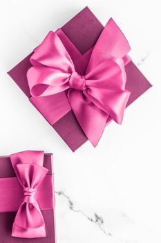 Birthday, wedding and girly branding concept - Pink gift box with silk bow on marble background, girl baby shower present and glamour fashion gift for luxury beauty brand, holiday flatlay art design