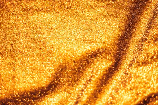 Luxe glowing texture, night club branding and New Years party concept - Golden holiday sparkling glitter abstract background, luxury shiny fabric material for glamour design and festive invitation