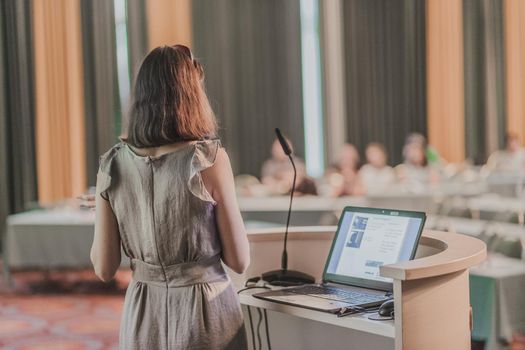 Female speaker at Business Conference and Presentation. Audience at the conference hall. Business and Entrepreneurship. Business woman. Horizontal composition.