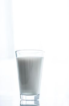 Dairy, healthy nutrition and breakfast concept - World Milk Day, full glass on marble table