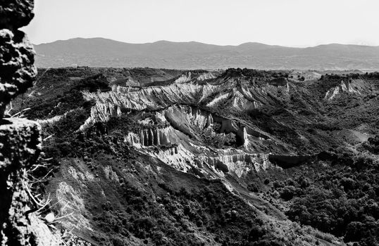 View of the valley of the badlands -valle dei calanchi - near Civita di Bagnoregio ,Italy , the morphology is caused by erosion and landsliders