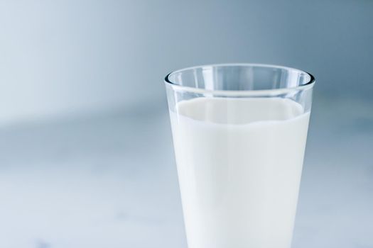 Dairy, healthy nutrition and breakfast concept - World Milk Day, full glass on marble table