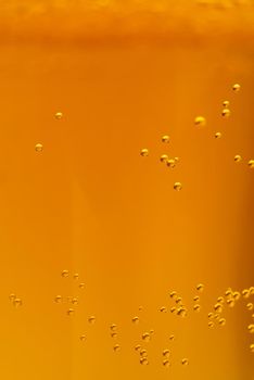 Beer textute can be usedas background. soft focus. Close up of beer with few bubbles and copy space. Fresh golden beer drink in glass.