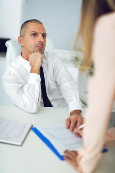 Businessman discussing plan with his female colleague in the office.