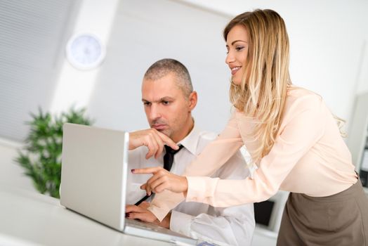 Professional male and female business partners having meeting to discuss planning strategy for common startup project.