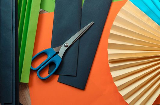 sheets of colored paper, scissors, blanks for origami. blanks for paper fan. Template for design, advertisement or text.