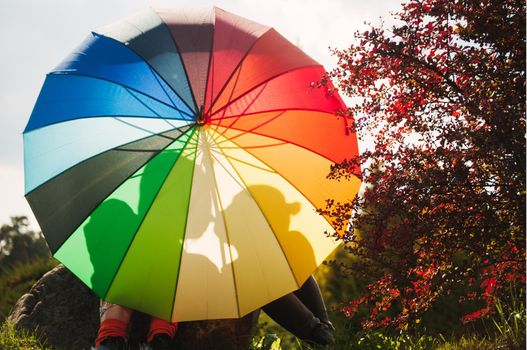 young couple of girls. Girls in love with lgbt umbrella. Two kissing girls Concept. Silhouette of two girls in love.