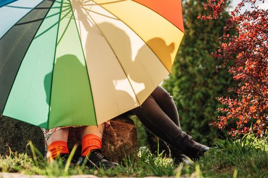 young couple of girls. Girls in love with lgbt umbrella. Two kissing girls Concept. Silhouette of two girls in love.