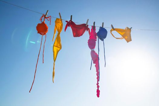 Time and desire for the summer season, colorful women's costumes lying in the sun to dry. 