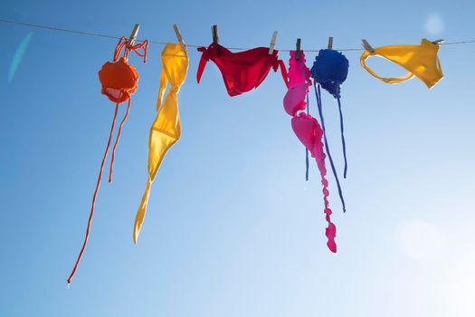 Time and desire for the summer season, colorful women's costumes lying in the sun to dry. 