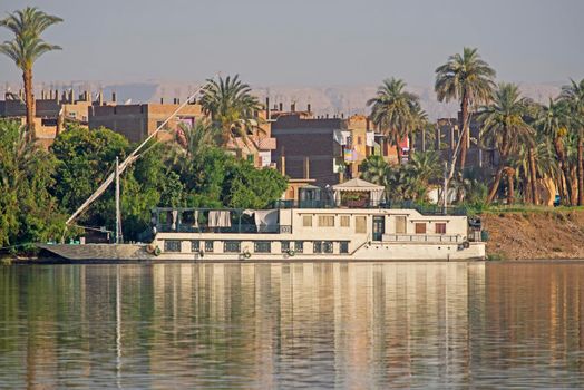 Large luxury traditional Egyptian dahabeya river cruise boat moored on the Nile