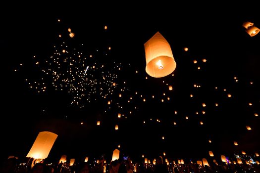 Floating lanterns on sky in Loy Krathong Festival or Yeepeng Festival , traditional Lanna Buddhist ceremony in Chiang Mai, Thailand