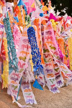 Paper flag on the pile of sand or Sand pagoda in Songkran festival at Temple in Muang, Chiang Mai, Thailand.  A Believe of people in the deceased relative to Paradise.