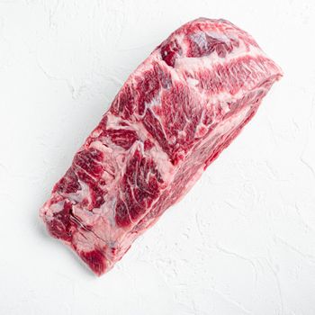 Raw dry aged Kobe Entrecote Steak set, square format, on white stone background