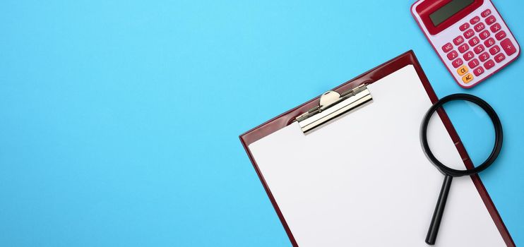 pink calculator, folder with blank white sheets and black magnifier on a blue background. Banner for business, top view