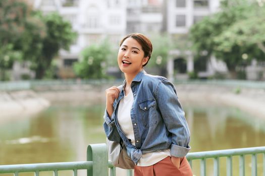 Portrait of young stylish hipster woman walking on the street, wearing trendy outfit, travel with backpack.