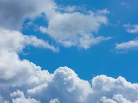 Blue sky with layer of fluffy cumulus clouds
