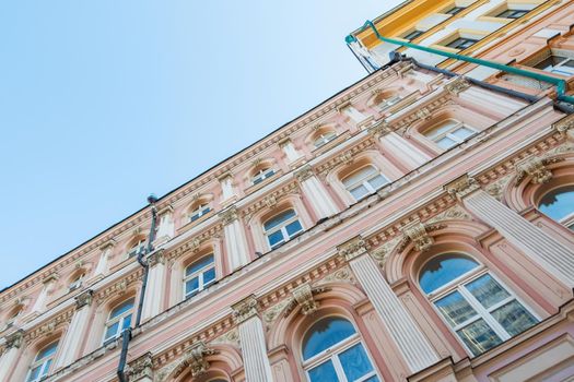 Beautiful facade of an old building with lots of windows, against a blue sky