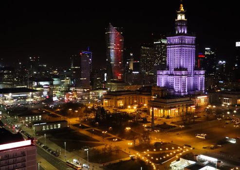 Warsaw / Poland - March 2019: Aerial view of the city center at night. Palace of Culture and Science and Business Skyscrapers