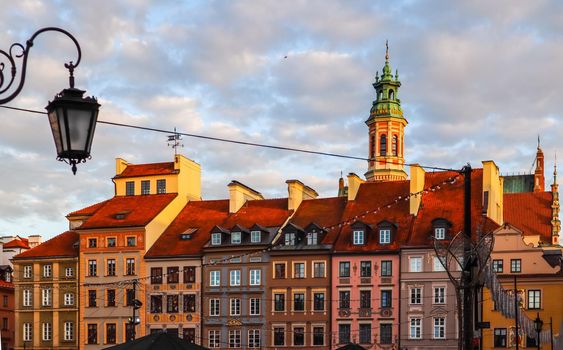 Historical buildings at Market Square of the Old Town with Christmas decorations in sunset. Warsaw, Poland