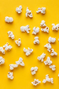 Popcorn on a yellow background. Vertical image. Top view.