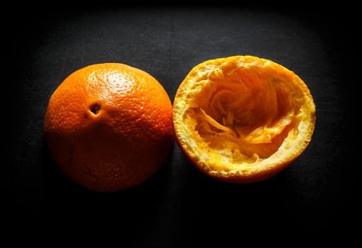 Used orange skins with dramatic light on black background. Horizontal image.