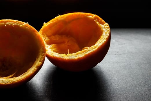 Used orange skins with dramatic light on black background. Horizontal image.