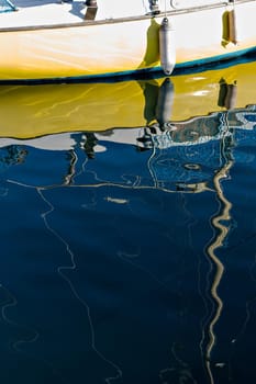 Pleasure boat with reflections in the water in the marina.