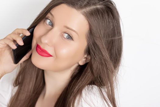 Happy smiling woman calling on smartphone, portrait on white background. People, technology and communication concept.