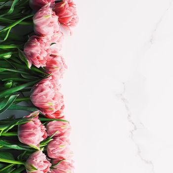 Spring flowers on marble background as holiday gift, greeting card and floral flatlay concept