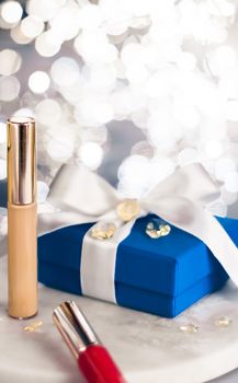 Cosmetic branding, Christmas glitter and girly blog concept - Holiday make-up foundation base, concealer and blue gift box, luxury cosmetics present and blank label products for beauty brand design