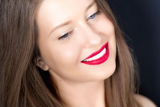Happy smiling young woman with perfect white teeth and beautiful healthy smile, clean skin and natural makeup, female face portrait with positive emotion, beauty, wellness and skincare ad.