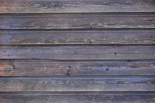 Old grey wood textured background. Natural hardwood material. Rough weathered wooden surface. Aged striped wooden background with copy space. Grey cracked and scratched wooden planks
