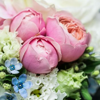 Beautiful flower bouquet arrangement close up in pastel colors. Decoration of roses and decorative plants, selective focus