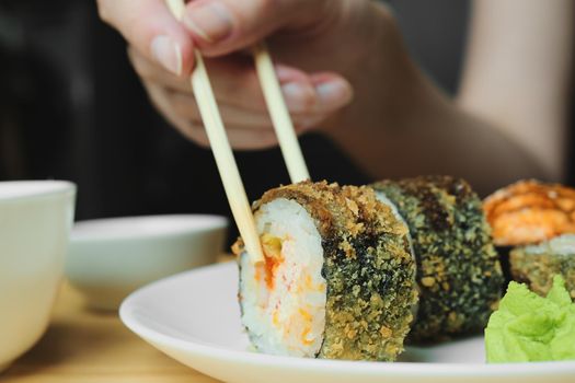 Japanese kitchen. Set of Japanese sushi and rolls. Food sticks.