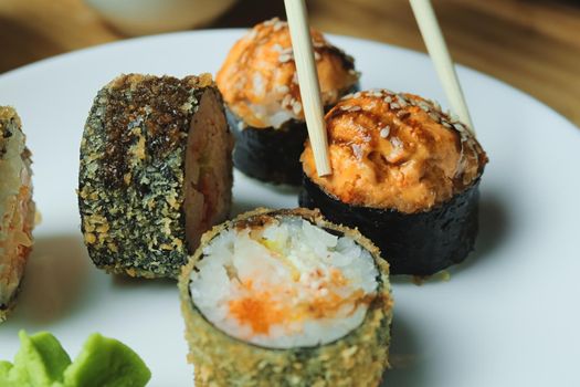 Japanese kitchen. Set of Japanese sushi and rolls. Food sticks.