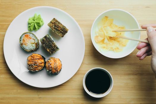 Japanese kitchen. Set of Japanese sushi and rolls. Food sticks.