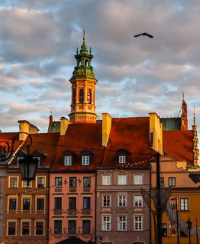 Historical buildings at Market Square of the Old Town with Christmas decorations in sunset. Warsaw, Poland