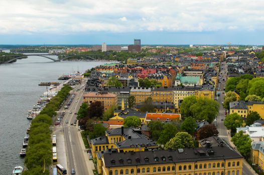 Sweden Stockholm. View of the cityscape, roads, bridges and pier with boats from observation deck of Town Hall.