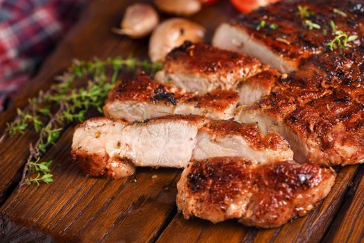  Sliced fried pork steak on a wooden board for serving