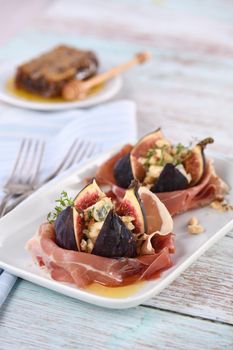 Figs stuffed with blue cheese, wrapped in Parma ham, drizzled with honey