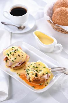 Eggs Benedict - fried English bun, ham, poached eggs and delicious Hollandaise   butter sauce