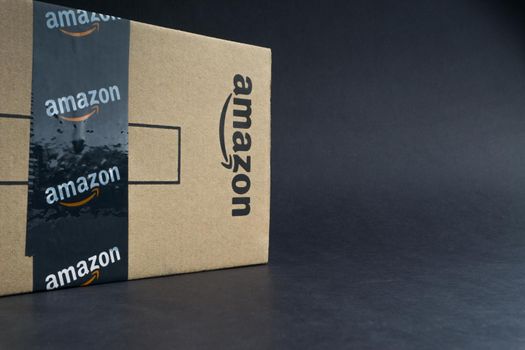 Kuala Lumpur, Malaysia - April 1, 2020 : Amazon Prime box or Amazon shipping box on black background. Crop fragment, business concept
