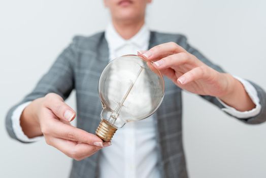 Lady Holding Lamp With Formal Outfit Presenting New Ideas For Project, Business Woman Showing Bulb With Two Hands Exhibiting New Technologies, Lightbulb Presenting Another Openion.