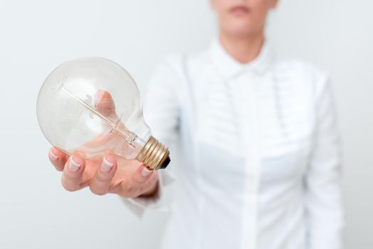 Lady Holding Lamp With Formal Outfit Presenting New Ideas For Project, Business Woman Showing Bulb With One Hand Exhibiting New Technologies, Lightbulb Presenting Another Openion.