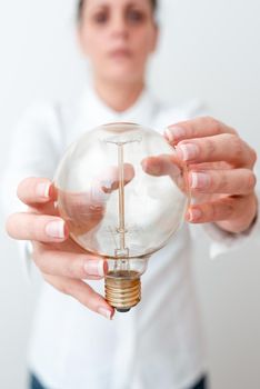 Lady Holding Lamp With Formal Outfit Presenting New Ideas For Project, Business Woman Showing Bulb With Two Hands Exhibiting New Technologies, Lightbulb Presenting Another Openion.