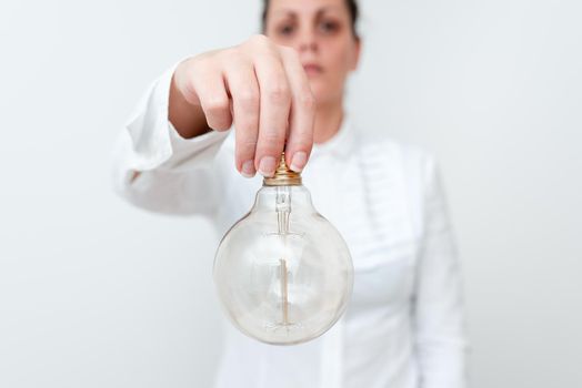 Lady Holding Lamp Upside Down In Shirt Presenting New Ideas For Project, Business Woman Carrying Bulb Opposite Showing Late Technologies, Vise Versa Lightbulbs Exhibiting Fresh Opinion.