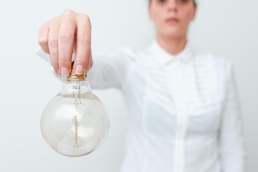 Lady Holding Lamp Upside Down In Shirt Presenting New Ideas For Project, Business Woman Carrying Bulb Opposite Showing Late Technologies, Vise Versa Lightbulbs Exhibiting Fresh Opinion.